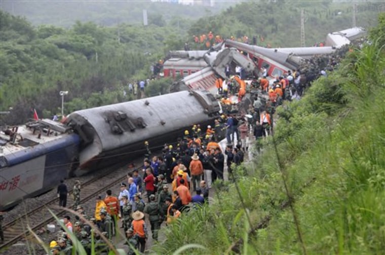 Rescuers work at the site where a passenger train derailed in Dongxiang County in China on Sunday.